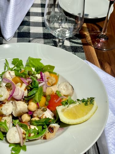 A chickpea and arugula salad with a lemon wedge