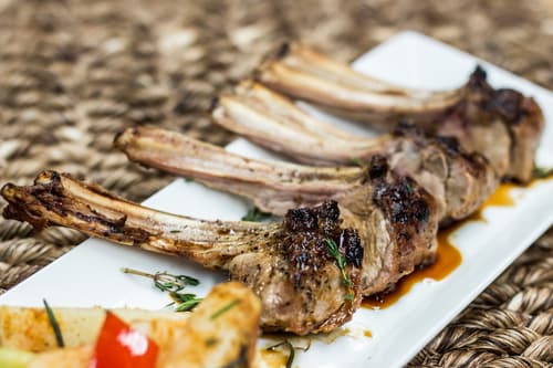 Grilled lamb chops on a woven mat
