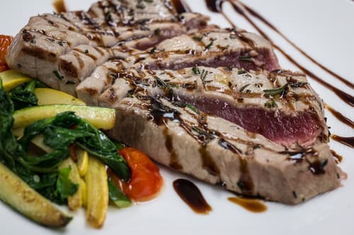 Sliced seared tuna with zucchini and a dark glaze