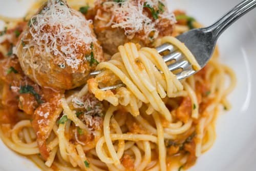 Spaghetti and meatballs with grated cheese