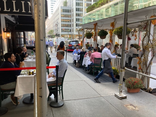 Outdoor sidewalk tables in front of Cellini